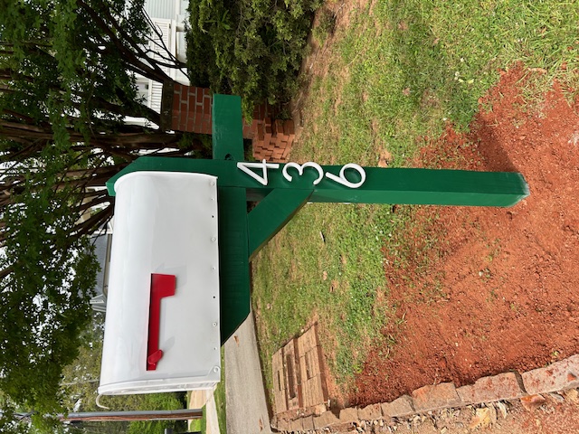 Green and white standard mailbox